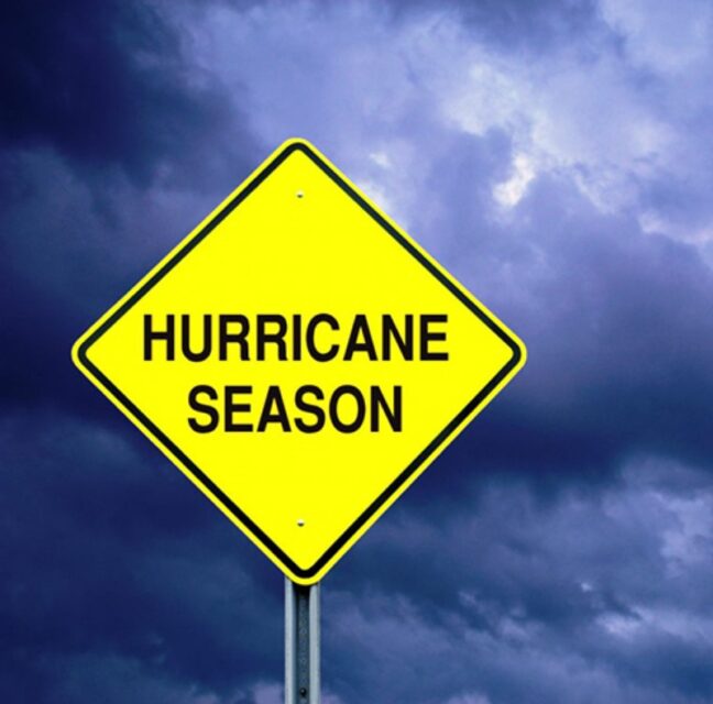 Hurricane Season warning sign against a stormy sky