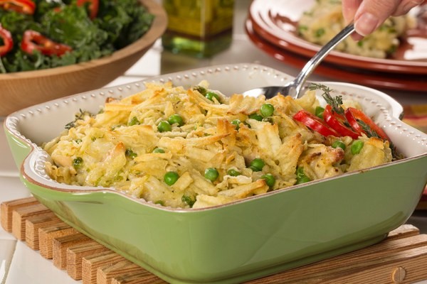 Everyday chicken casserole with peas and a potato chip topping in a baking dish