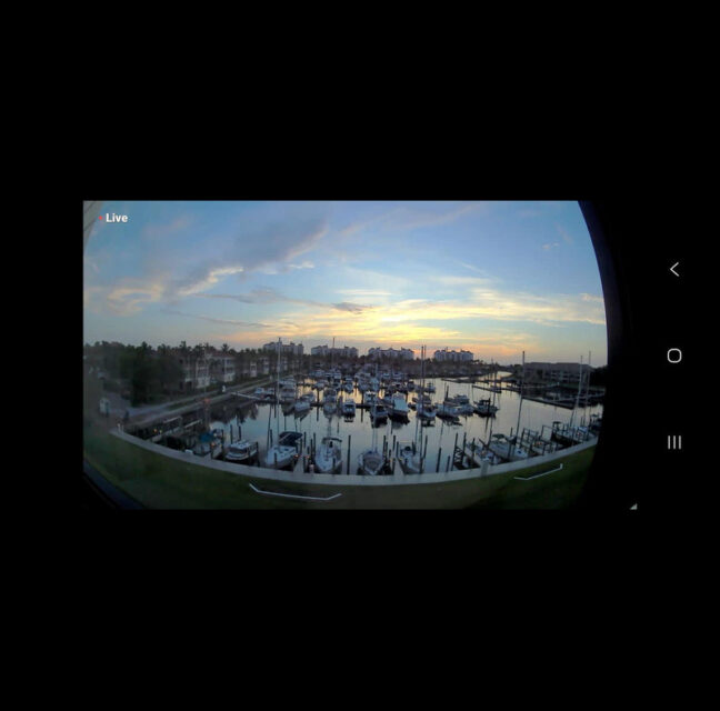 Webcam view of boats in their slips at Burnt Store Marina at dusk